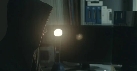 Male hacker in dark office doing cyber crime Stock Footage 78037582