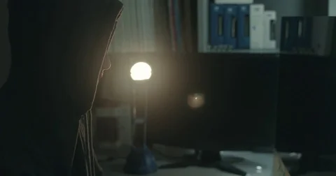Male hacker in dark office doing cyber crime Stock Footage 78037617