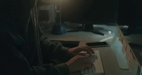 Male hacker in dark office doing cyber crime Stock Footage 78037618