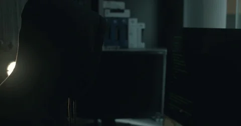 Male hacker in dark office doing cyber crime Stock Footage 78037637