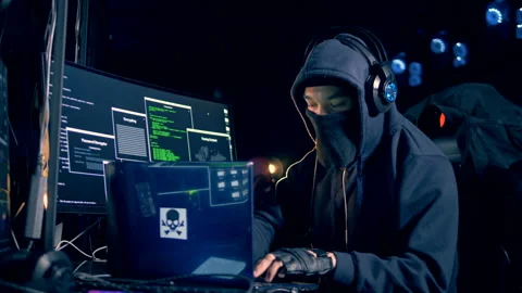 Male hacker in a hoodie is operating computers Stock Footage 101573963