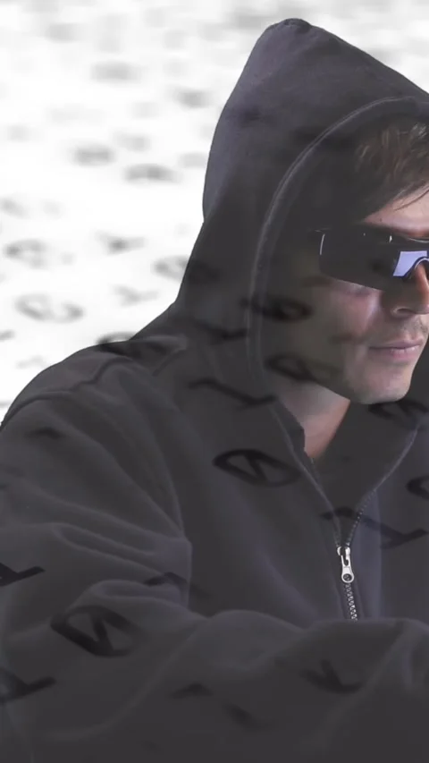 Male hacker with laptop on binary background symbolizes online security. Video stock 342802550