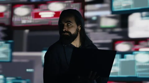 Male hacker operates in stealth mode breaching system access through coding Stock Footage 311082538