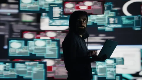 Male hacker operates in stealth mode breaching system access through coding Stock Footage 311135176