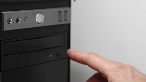 A male hacker programmer opens a drive with a CD-DVD drive. Obsolete storage Stock-Footage 126975179