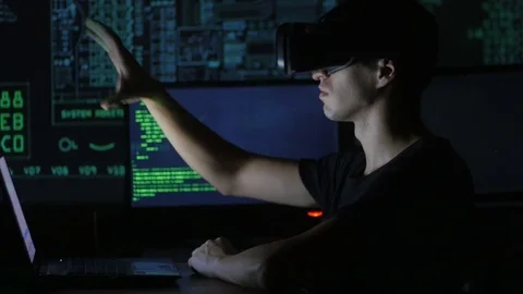 Male hacker programmer uses a virtual reality helmet for programming. IT Stock Footage 80267949