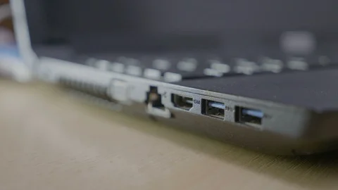 Male hacker stealing information with an usb data stick from a laptop hurryin Stock Footage 87014282