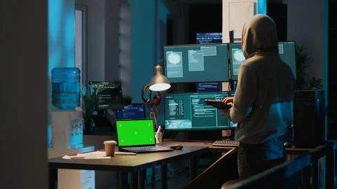 Male hacker using greenscreen to break into IT server 스톡 사진