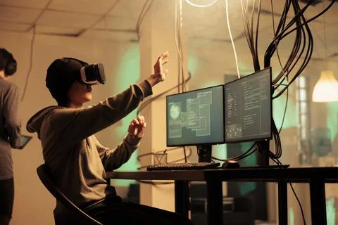 Male hacker using vr glasses to hack computer system Stock Photos