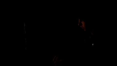 Male hacker working on a computer in a dark office room 스톡 동영상 77167089