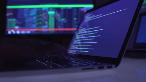 Male hacker working on a computer in a dark office room. Stock Footage 81465989
