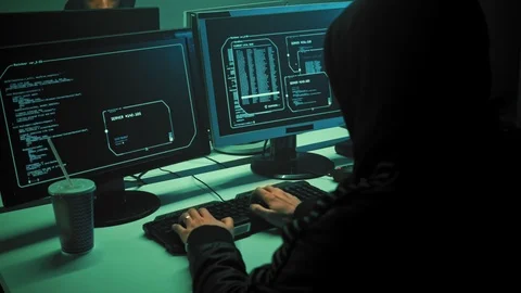 Male hacker working on a computer in a dark office room. 4K (UHD) Stock Footage 111487251