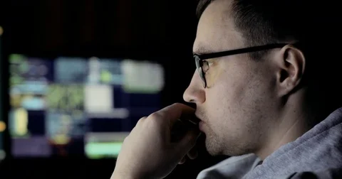 Male hacker working on a computer. hacker in glasses is working on computer in Stock Footage 83877482