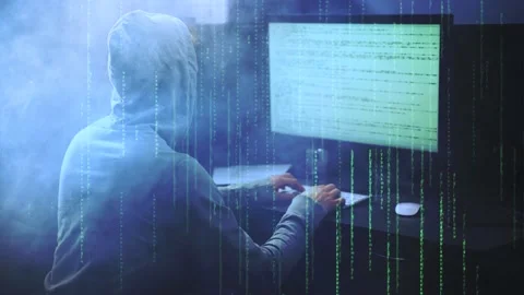 Male hacker working on a computer vs Green Matrix code and smoke on background Stock Footage 132352192