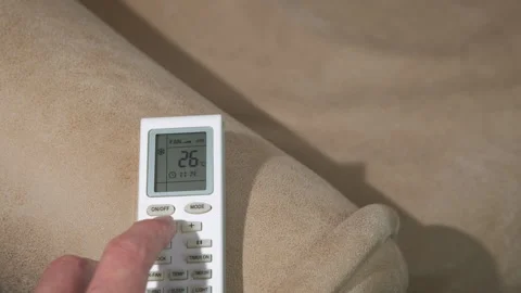 Male hand adjust a temperature on remote control Stock Footage 300803612