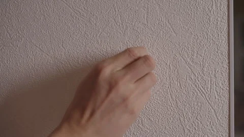 Male hand applying adhesive solution by peeling protective layer from Stockbeeldmateriaal 325714857