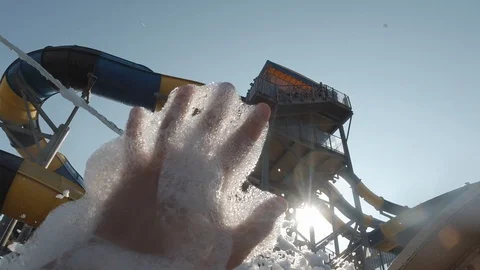 Male hand on the background of a large amount of foam. Foam bubbles fly in the Stock Footage 115055085