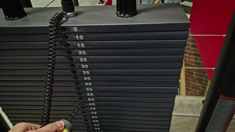 Male hand change weight of stack plates Stock Footage 151179046