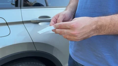 Male hand is checking or viewing supermarket check or shopping receipt. Folding Stock Footage 282365619