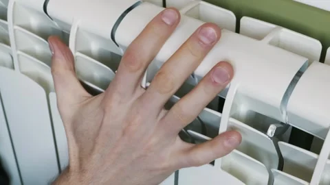 Male Hand Checking Temperature of a White Central Heating Radiator at Home Stock Footage 329403103