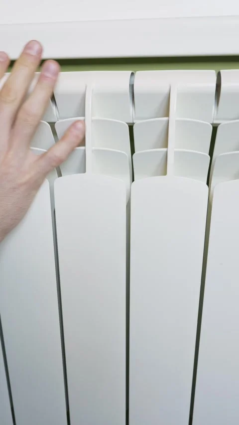 Male Hand Checking Warmth On White Radiator In Modern Home Interior Stock Footage 328480495