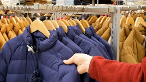 Male hand chooses colored jackets in clothing store close-up. Stock Footage 167620602