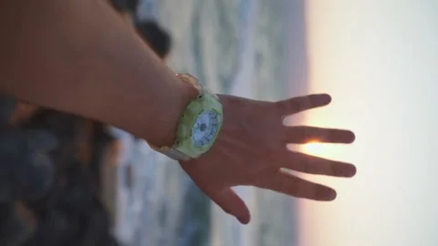 Male hand close-up at sunset, the rays of the setting sun Stock Footage 159586669