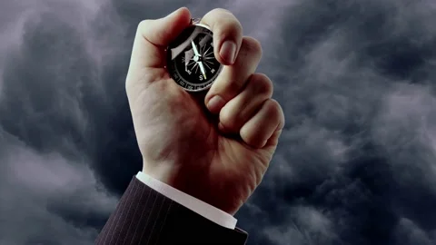 A male hand with compass on cloudy sky Video stock 236478880