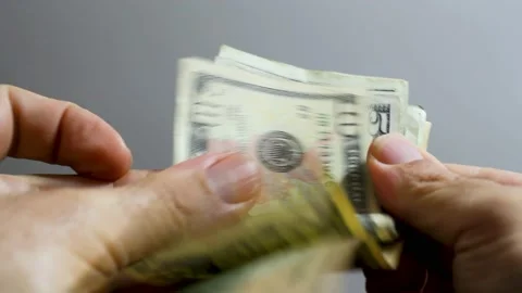 Male hand counting dollars banknotes. Selective focus of a man with American Stock Footage 201529815