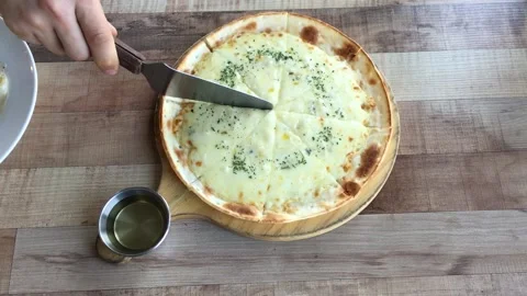 Male hand cuts a slice of pizza top view. Video stock 130842590