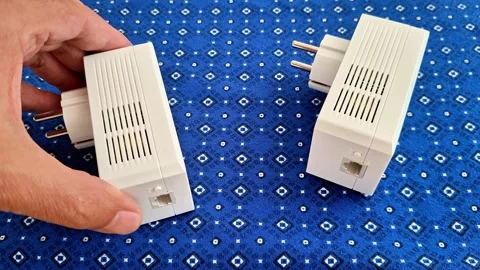 Male Hand Demonstrating Two White Home Network Powerline Adapters Stock Footage 341840580
