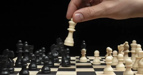 A male hand doing a checkmate to the black pieces on a chess board Video stock 328319711