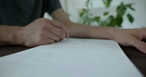 Male hand draw a drawing on sheet of paper. 4K 10-bit Stock Footage 345234063