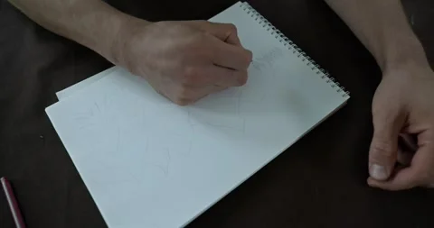 Male hand draw a drawing on sheet of paper. 4K 10-bit Stock Footage 345234076