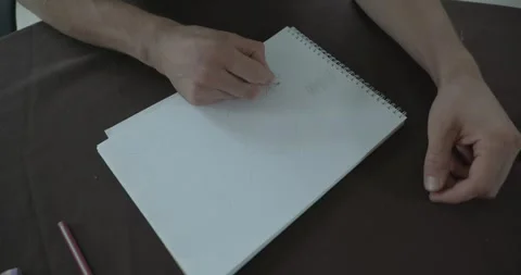 Male hand draw a drawing on sheet of paper. 4K 10-bit Stock Footage 345234220