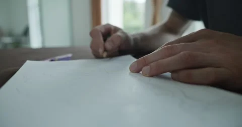 Male hand draw a drawing on sheet of paper. 4K 10-bit Stock Footage 345236142