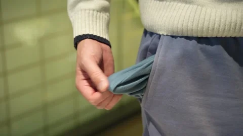 Male hand with empty pockets closeup Video stock 323359125