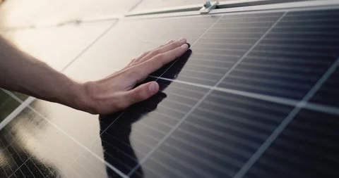 The male hand of an engineer strokes the surface of a solar panel Stock Footage 156524773