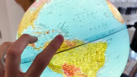 Male hand on a globe model Stock Footage 260692819