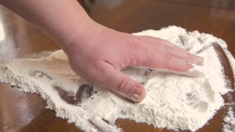 Male hand hits the table with a pile of wheat flour Stock Footage