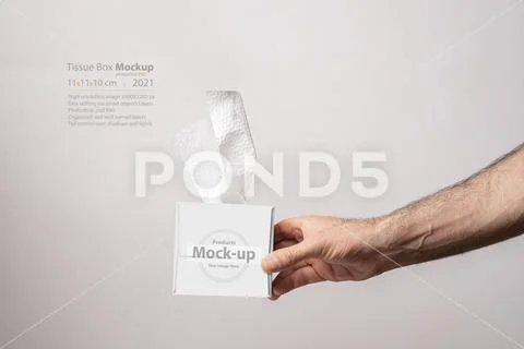 Male hand holding a cubical tissue box on white background mock-up series PSD Template