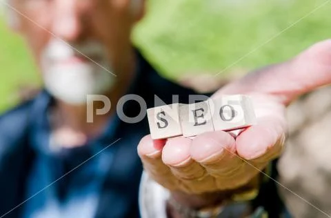 Male hand holding SEO lettering for website optimization and increase traffic Stock Photos