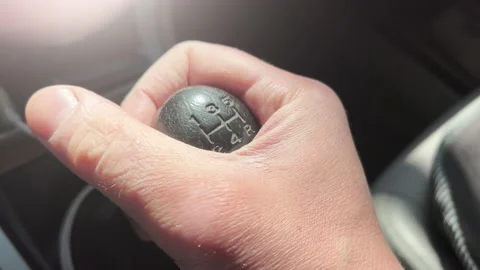 A male hand holds a manual gearshift knob. Closeup 스톡 동영상 181096653