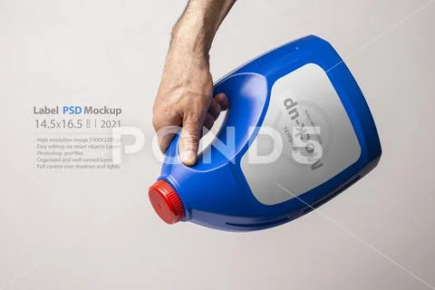 A male hand holging a blue kitchen detergent bottle with closed cap mock-up PSD Template
