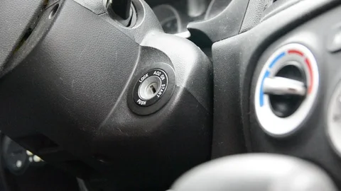 Male hand inserting car key into lock and starting engine close-up Video stock 123100638