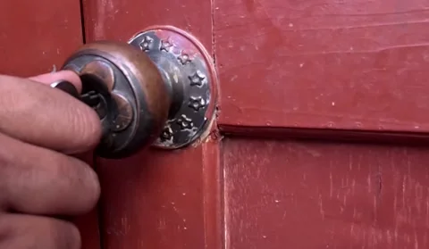 Male hand inserting key in old lock of wooden door and opening Stock Footage 341322314