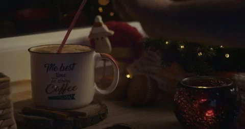 Male hand inserting a straw in a beverage in a cozy Christmas atmosphere. Stock Footage 120026705