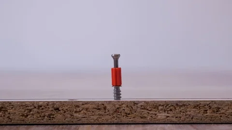 Male hand inserts the red cam lock screw into the board. Stock Footage 108609732