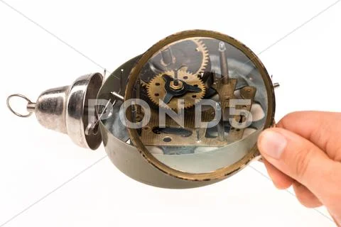 The male hand with magnifier and clockwork Stock Photos