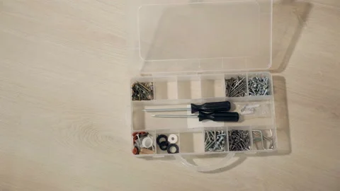 Male hand opens box for nuts, bolts, screws Stock Footage 100058995